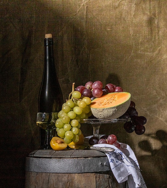 Still life of fruit and wine standing on an old wine barrel