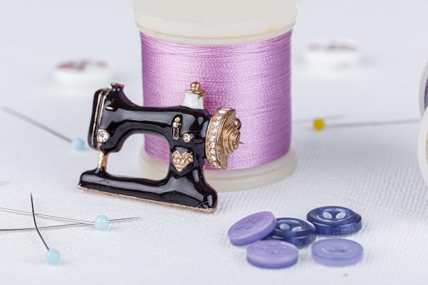 Still life of a skein of thread for sewing needles buttons sewing machine on a white background