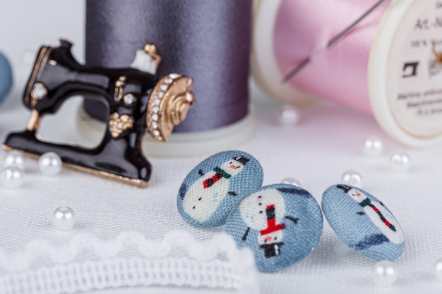 Still life of a skein of thread for sewing needles buttons sewing machine on a white background