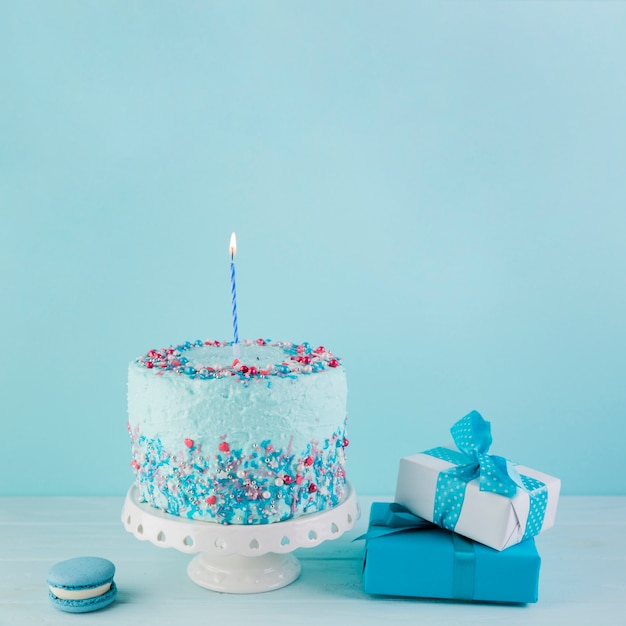 Still life of tasty birthday cake with presents