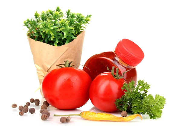 Still life tomatoes ketchup and herbs isolated on white