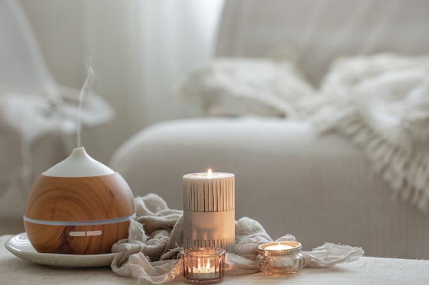 Still life with an aroma diffuser for moisturizing the air and burning candles.