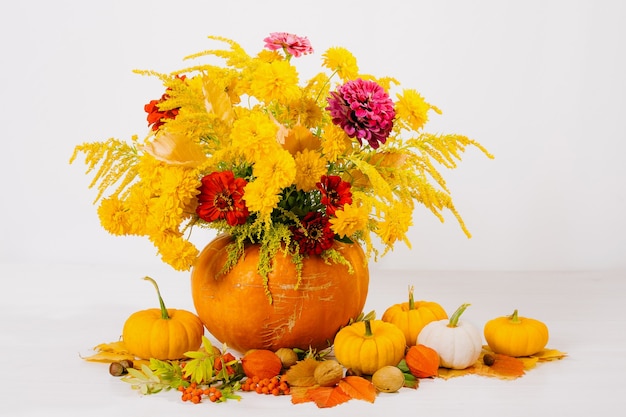 still life with bouquet of flowers in orange pumpkin on table Decoration for Thanksgiving day