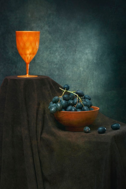 Still life with a bunch of grapes and a glass