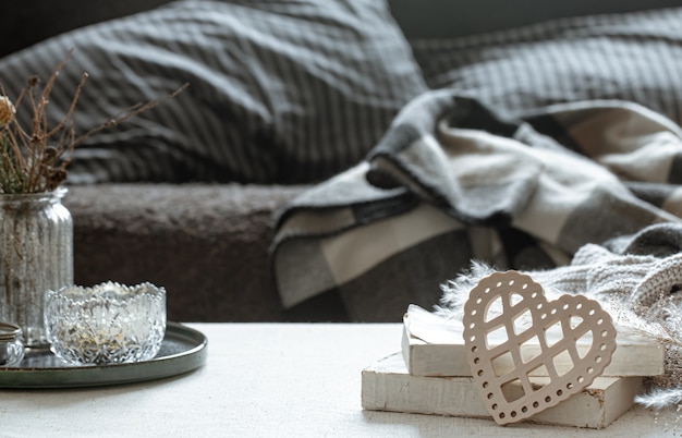 Still life with a decorative heart, books and cozy things for the home. The concept of Valentine's day and home comfort.