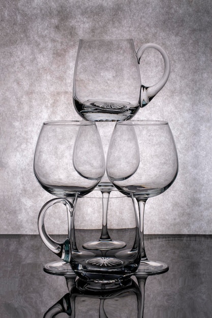 Still life with empty glass goblets on a gray background