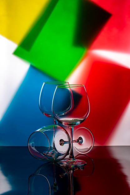 Still life with empty glasses on a colored background