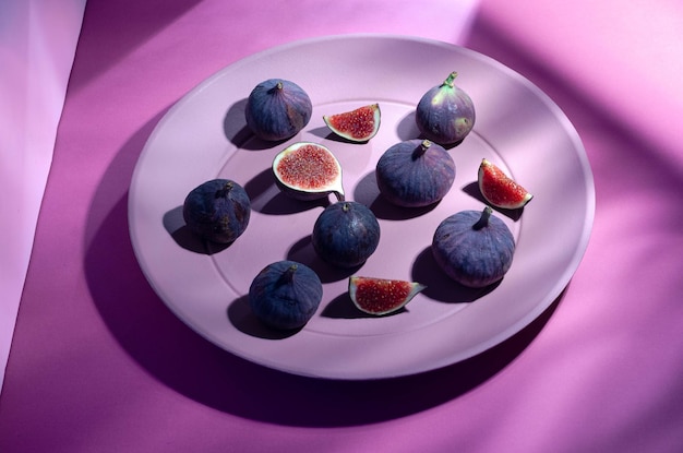 Still life with figs over a pink background