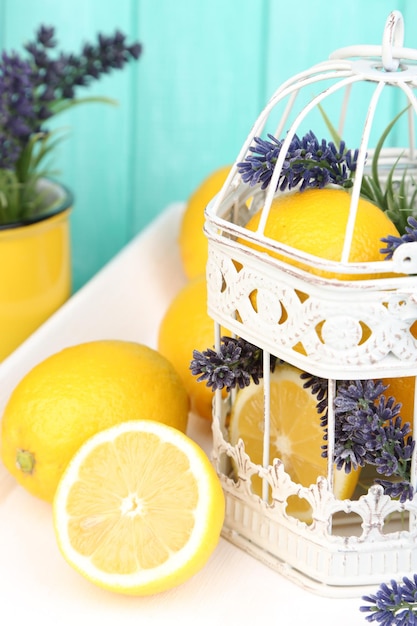 Still life with fresh lemons and lavender on blue background