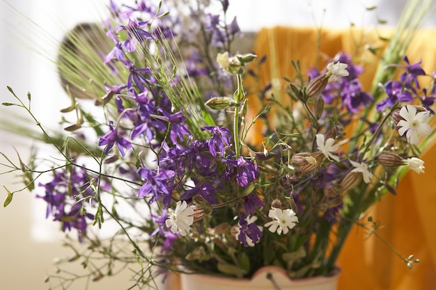 Still life with fresh wild flowers in vase