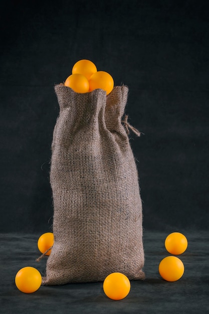 Still life with a full bag of orange balls