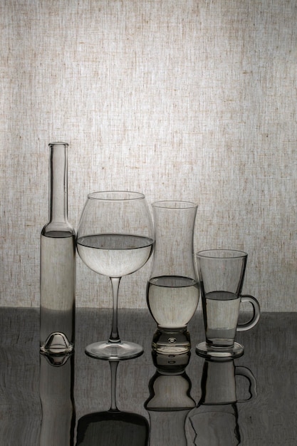 Still life with glassware on a reflective surface