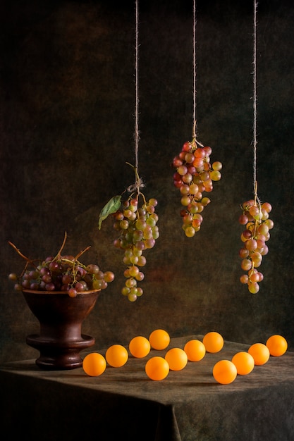 Still life with grapes and orange balls