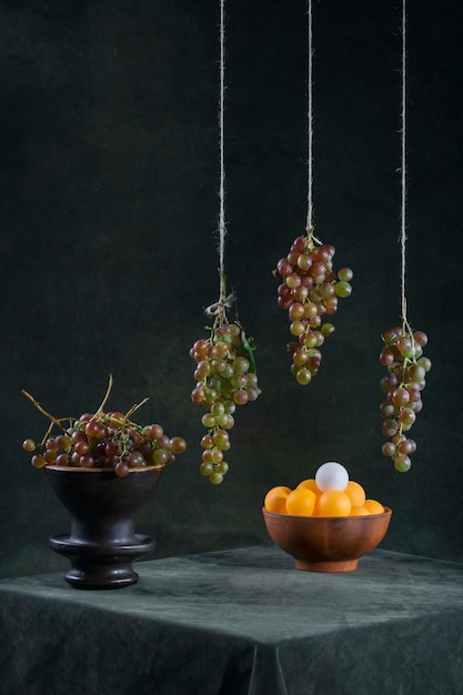 Still life with grapes and orange balls