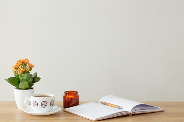 still life with house plant notepad pen and coffee cup in modern interior