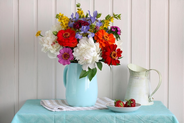 Still life with peonies zinnias and other garden flowers