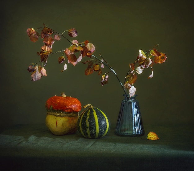 Still life with pumpkins and a branch. Vintage retro. Autumn. Autumn colors