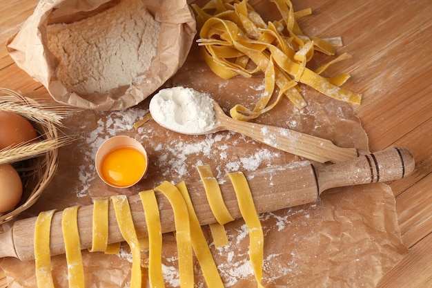 Photo still life with raw homemade pasta and ingredients for pasta