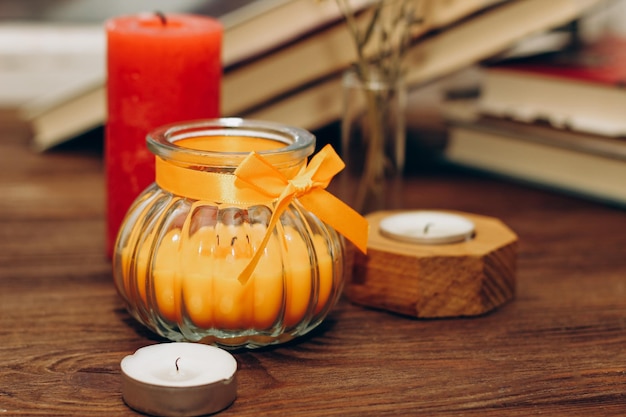 Photo still life with skins orange aroma candle in a figured candlestick