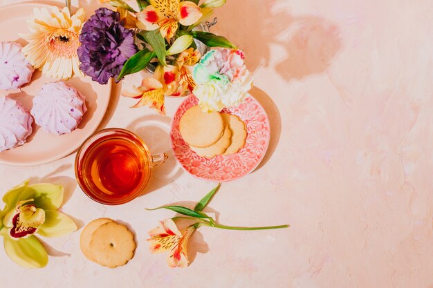 Still life with tea and flowers. Postcard for women's day