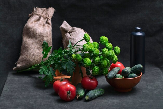 Still life with tomatoes cucumbers and a bouquet of chrysanthemums