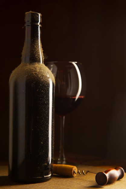 Still-life with vintage wine bottle and wineglass