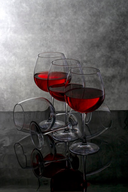 Still life with wine glasses on a reflective surface