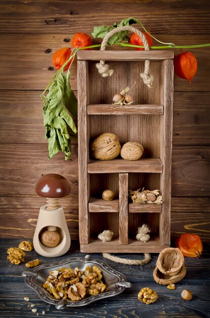 Still life with a wooden box and nuts. Vertical image