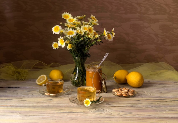 Still life Yellow daisies lemons and tea