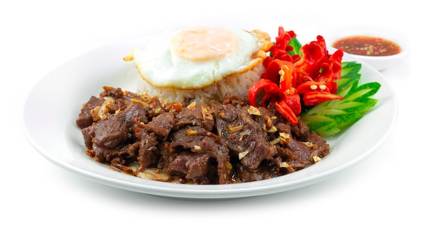 Stir Fried Beef with Garlic and Pepper Served Rice recipe ontop With Fried egg decoration carved chili and Cucumber Thaifood style sideview