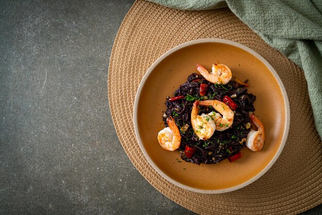 stir-fried black spaghetti with garlic and shrimps on plate