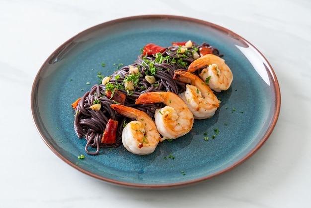 stir-fried black spaghetti with garlic and shrimps on plate