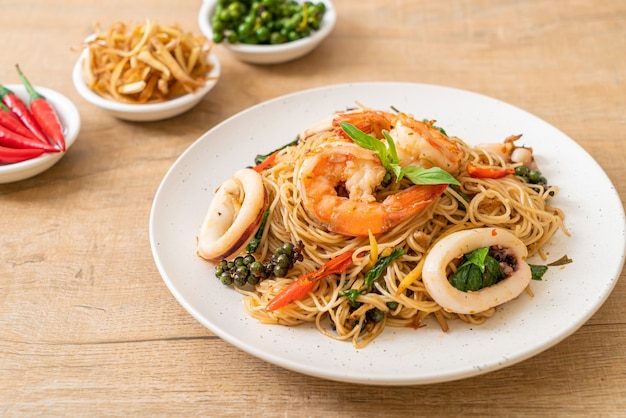 stir-fried Chinese noodle with basil, chilli, shrimps and squid - Asian food style