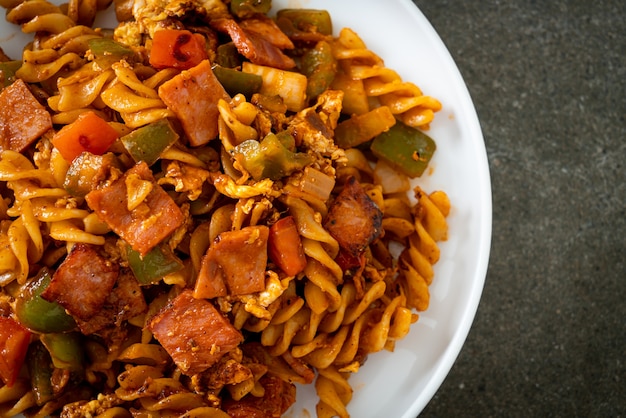 stir fried fusilli pasta with ham and tomatoes sauce