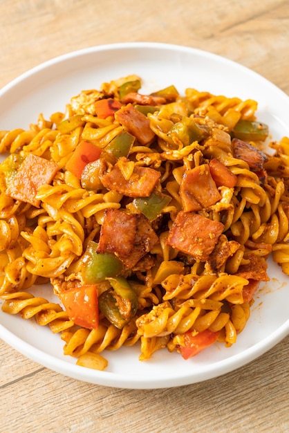 stir fried fusilli pasta with ham and tomatoes sauce