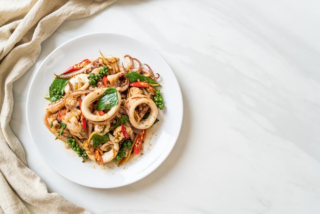 stir fried holy basil with octopus or squid and herb - Asian food style