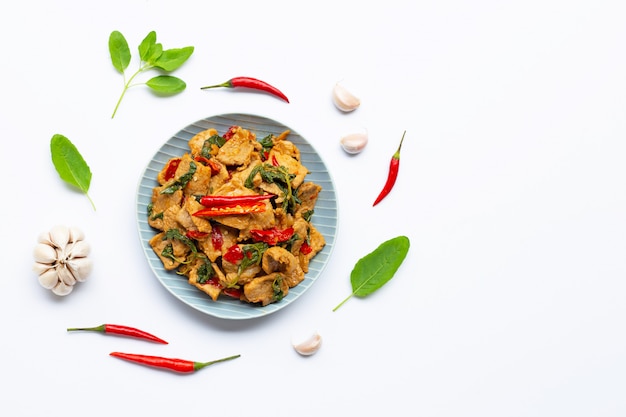 Stir-fried hot and spicy pork with basil on white