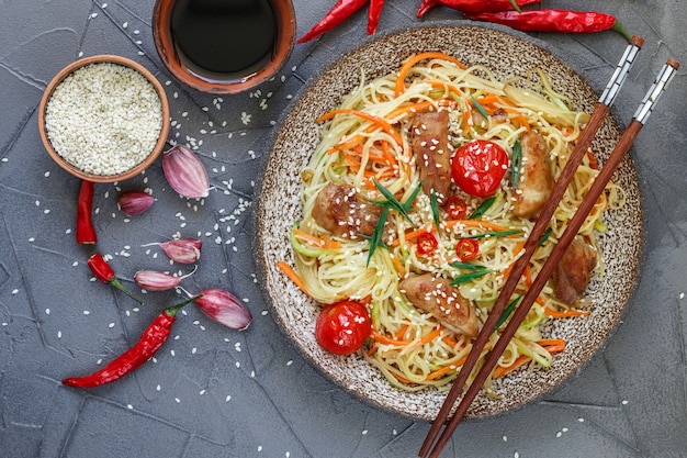 Stir fried noodle with chicken, vegetable , sesame seeds and soy sauce 