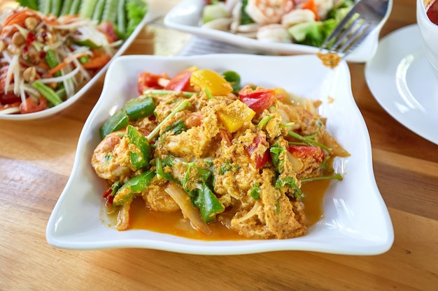 Stir Fried Shrimp with Curry Powder on wooden dining table Thai food