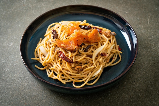 stir-fried spaghetti with salmon and dried chilli - fusion food style