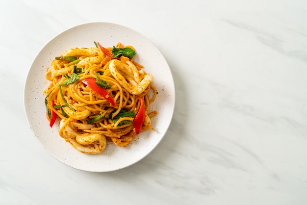 stir-fried spaghetti with salted egg and squid - fusion food style