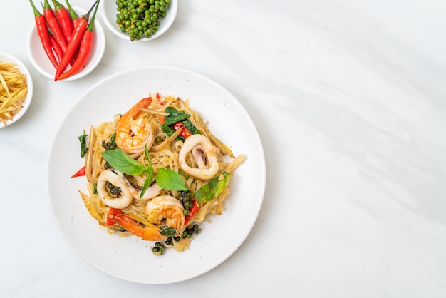 Stir fried spicy noodles with sea food and ingredients