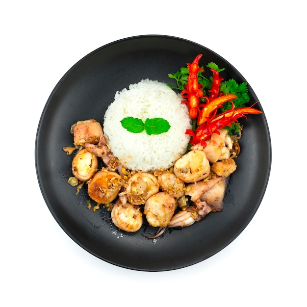 Stir Fried Squids with Garlic and peppers Served Rice recipe decoration carving Chili and vegetables topview