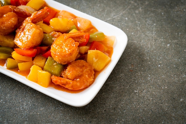 Stir-fried sweet and sour with fried shrimp on plate - Asian food style