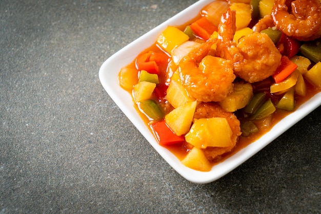 Stir-fried sweet and sour with fried shrimp on plate - Asian food style