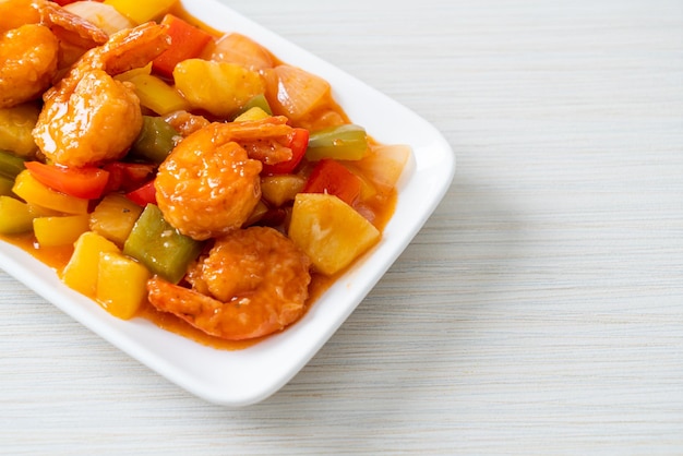 Stir-fried sweet and sour with fried shrimp on plate - Asian food style