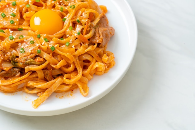 stir-fried udon noodles with kimchi and pork - Korean food style