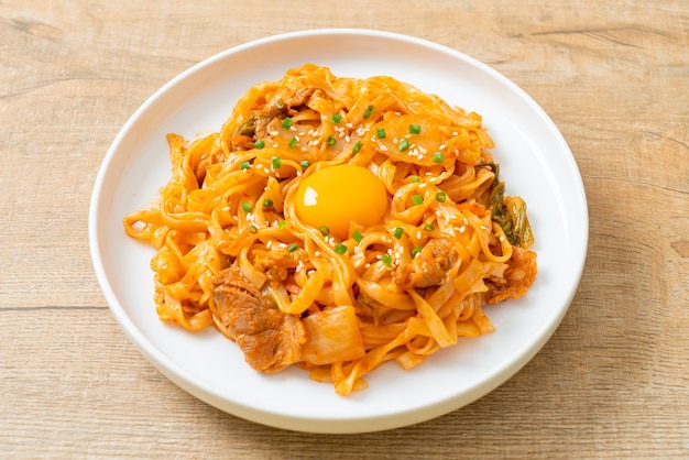 stir-fried udon noodles with kimchi and pork - Korean food style