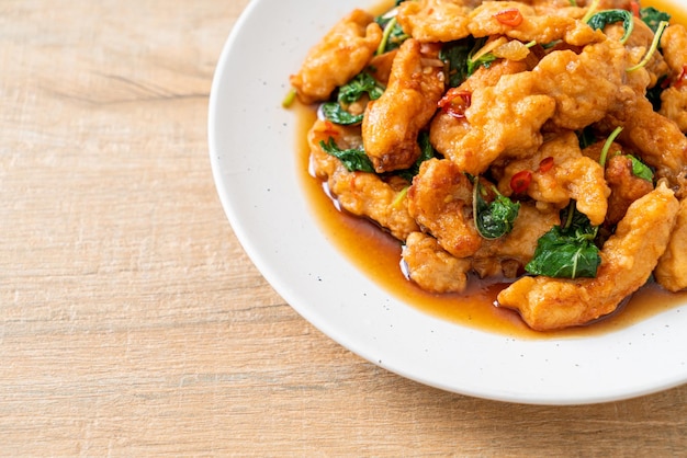 Stirfried fried fish with basil and chili in thai style