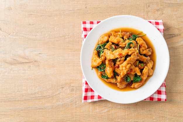 Stirfried fried fish with basil and chili in thai style